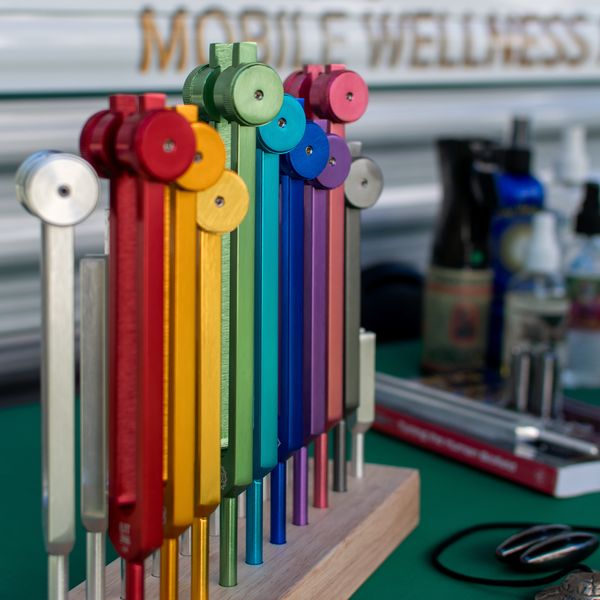 A rack of colour-coded tuning chimes set up on a table beside the Pod.