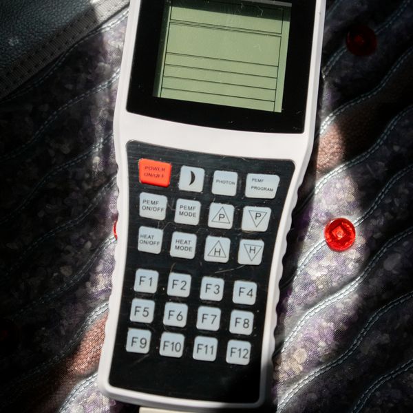 The HealthyLine controller resting on the gemstone-embedded infrared mat.